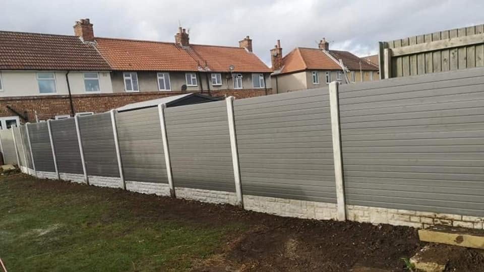 Grey composite fence panels on concrete posts installed by S&R Fencing Contractors